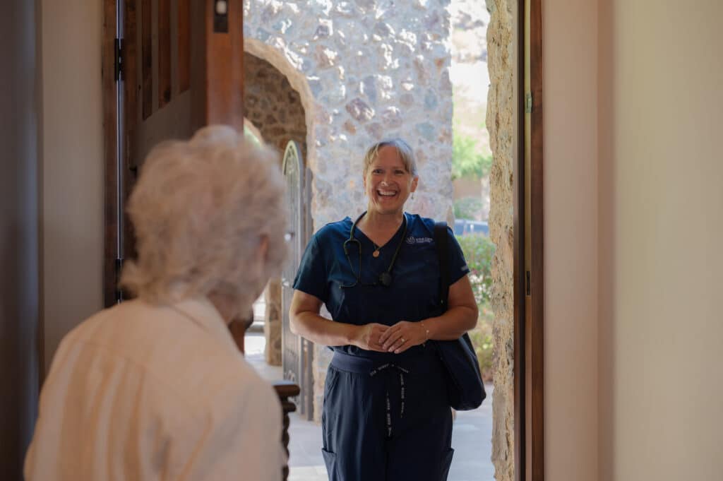 Caregiver being welcome by her client at home.