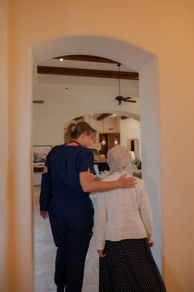 A caregiver guiding a client safely through their home.