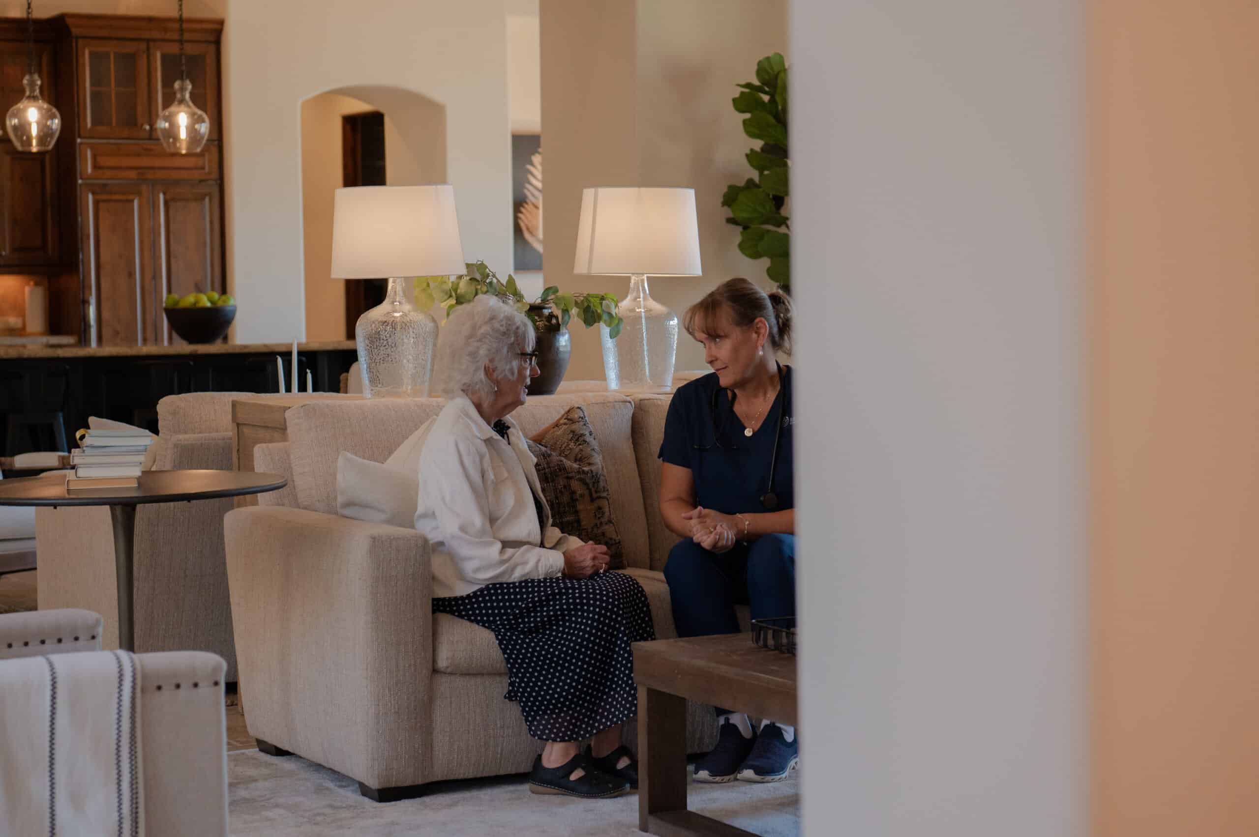 A caregiver checking in on a client and engaging in conversation.