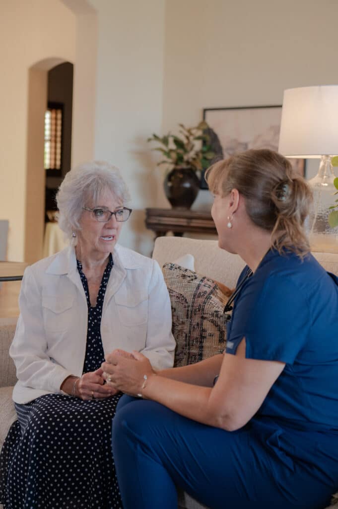 Client and caregiver sitting together, sharing a moment of bonding and happiness.