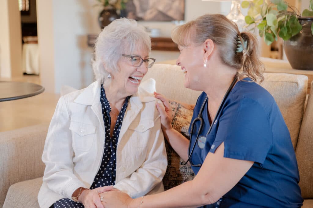 Client and caregiver sitting together, sharing a moment of bonding and happiness.