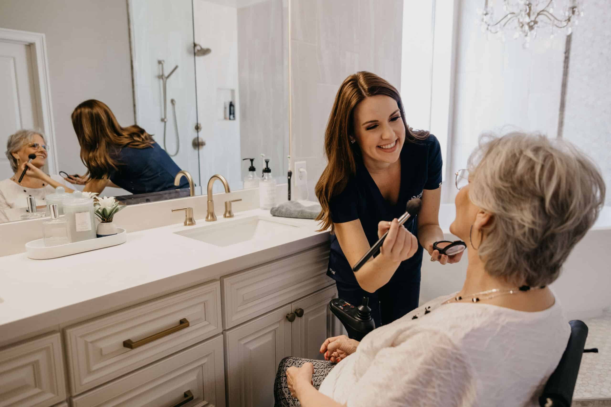Caregiver from Total Care Connections assisting senior woman with a makeup session as part of personal care services.
