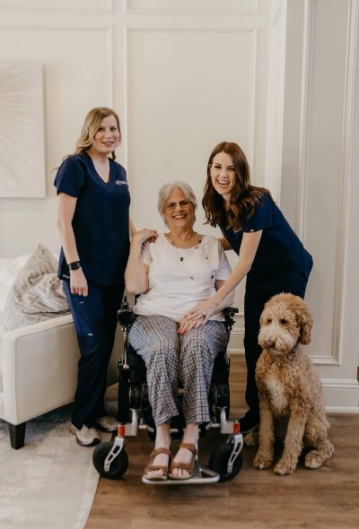 caregiver and nurse and elderly woman smiling