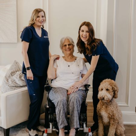 caregiver and nurse and elderly woman smiling